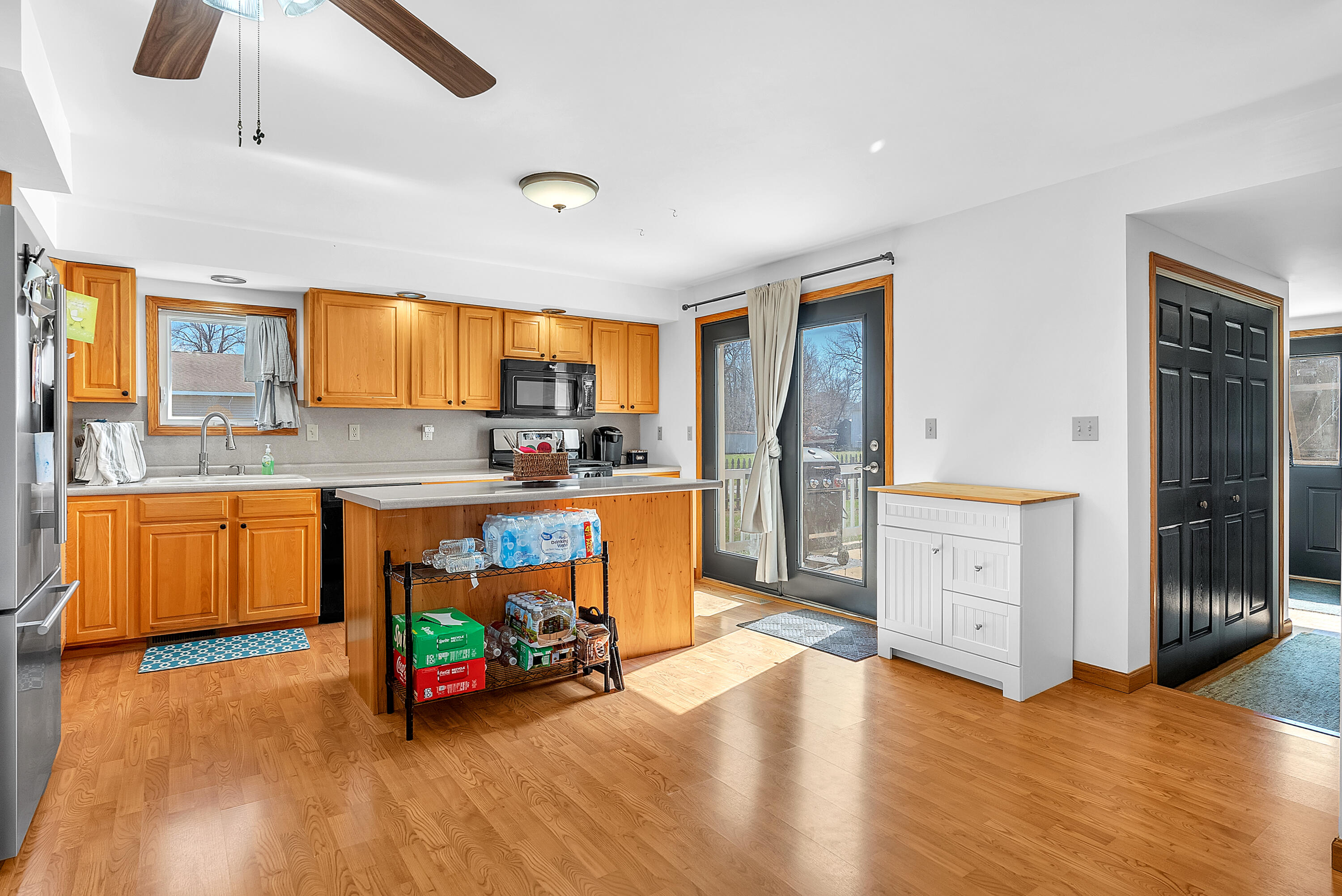 115 West Monroe Street Goodland, IN 47948 - Photo 9 of 36 a kitchen with stainless steel appliances granite countertop a stove a sink and a refrigerator
