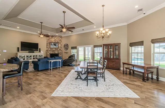 a kitchen with kitchen island granite countertop a sink cabinets and stainless steel appliances