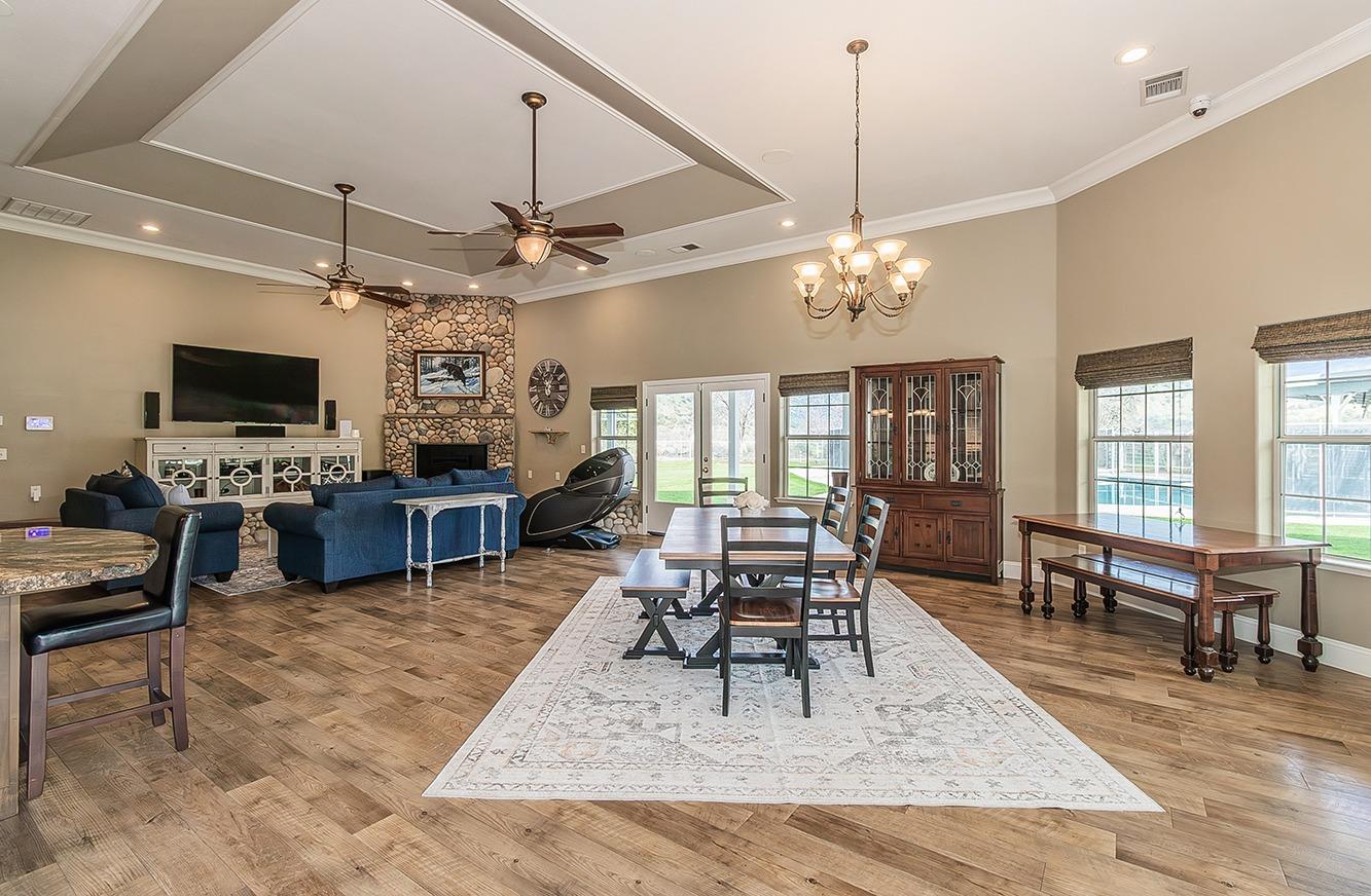 21777 Tollhouse Road Clovis, CA 93619 - Photo 14 of 99 a living room with furniture a chandelier and a flat screen tv