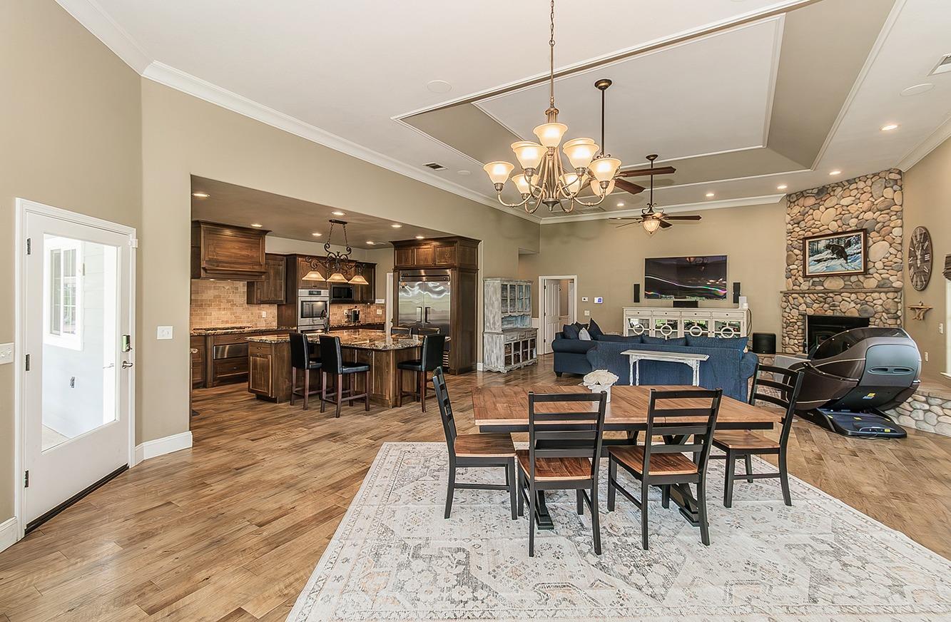 21777 Tollhouse Road Clovis, CA 93619 - Photo 15 of 99 a view of a dining room with furniture a chandelier and wooden floor