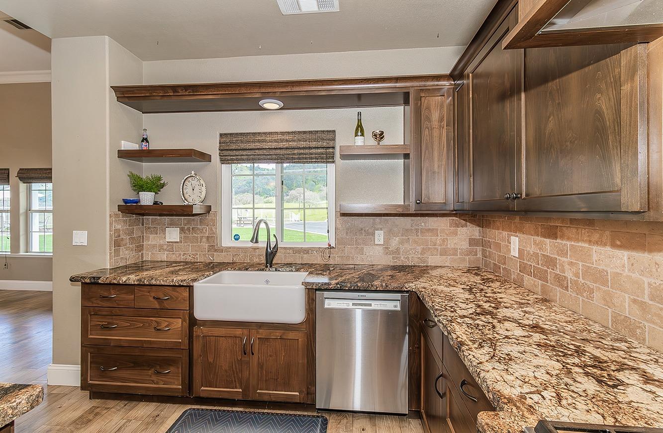 21777 Tollhouse Road Clovis, CA 93619 - Photo 18 of 99 a kitchen with kitchen island granite countertop a sink cabinets and stainless steel appliances