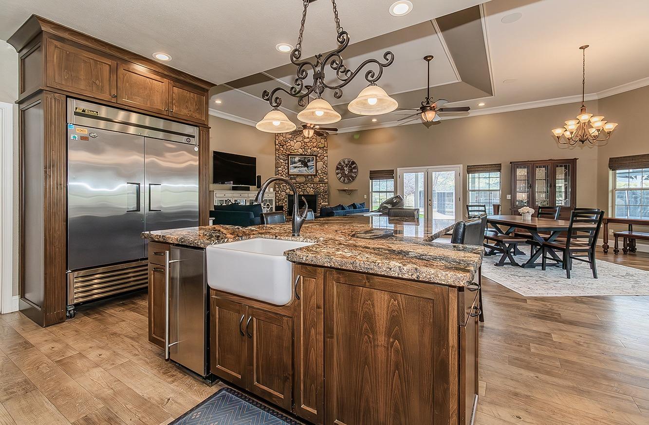 21777 Tollhouse Road Clovis, CA 93619 - Photo 19 of 99 a kitchen with stainless steel appliances granite countertop a stove and a refrigerator