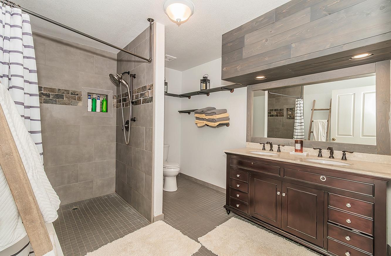 21777 Tollhouse Road Clovis, CA 93619 - Photo 29 of 99 a bathroom with a double vanity sink toilet mirror and shower