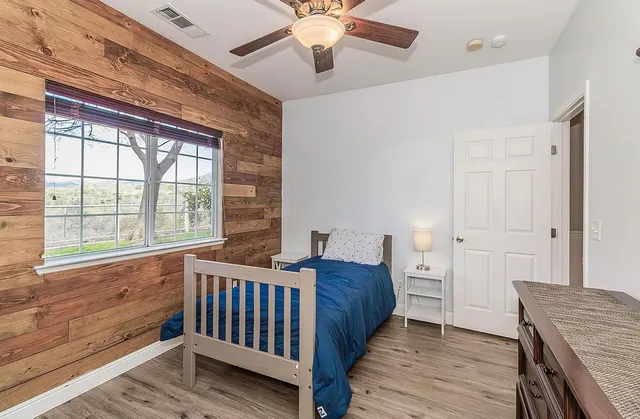 a bedroom with a bed and a chandelier