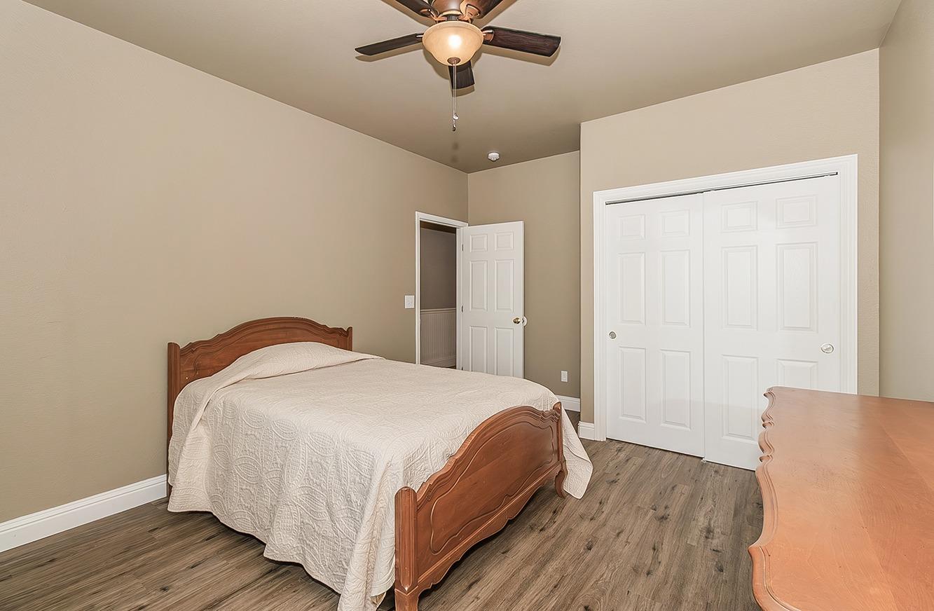 21777 Tollhouse Road Clovis, CA 93619 - Photo 38 of 99 a bedroom with a bed and wooden floor