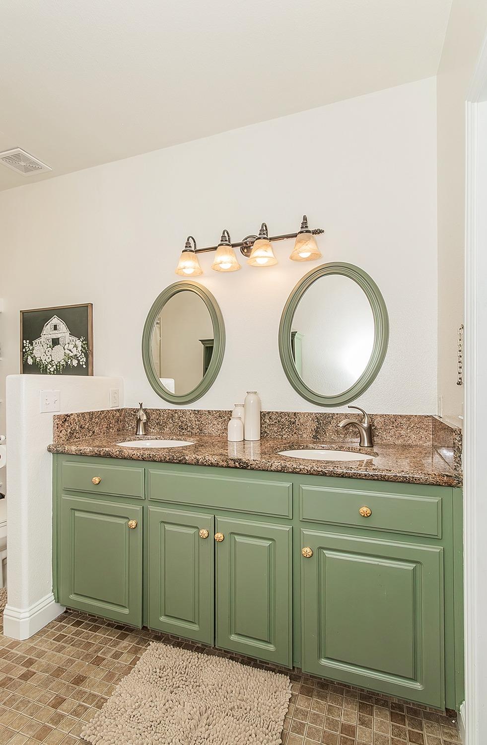 21777 Tollhouse Road Clovis, CA 93619 - Photo 40 of 99 a bathroom with a granite countertop toilet sink and a mirror