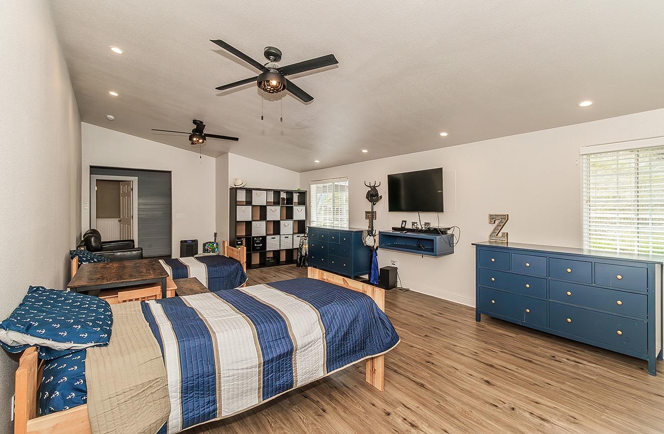 21777 Tollhouse Road Clovis, CA 93619 - Photo 46 of 99 a bedroom with a bed a couch and a flat screen tv