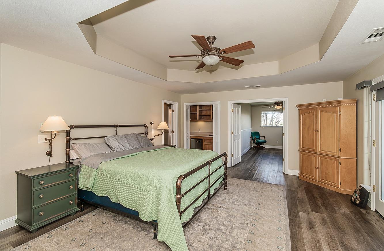 21777 Tollhouse Road Clovis, CA 93619 - Photo 50 of 99 a bedroom with a bed and a chandelier
