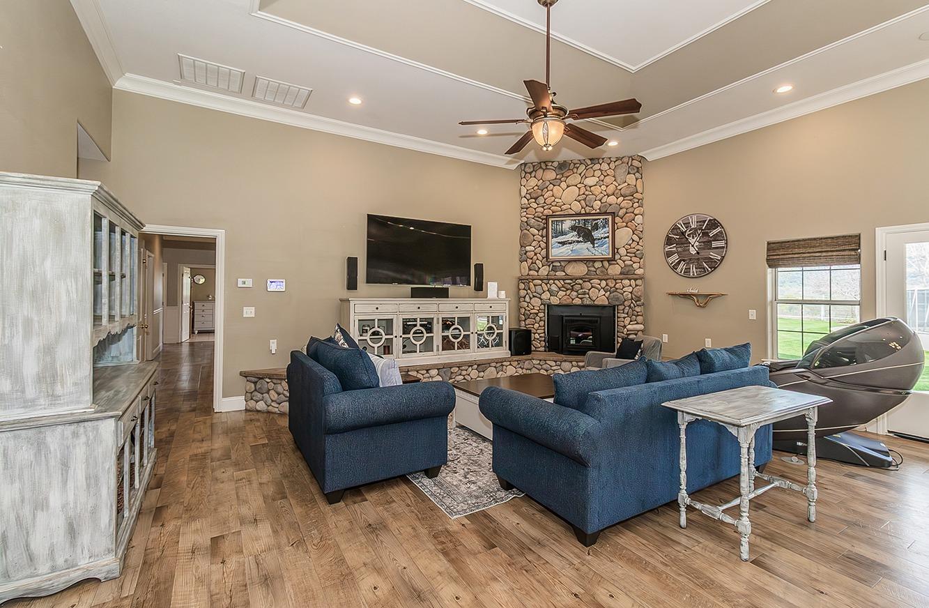 21777 Tollhouse Road Clovis, CA 93619 - Photo 8 of 99 a living room with fireplace furniture and a flat screen tv