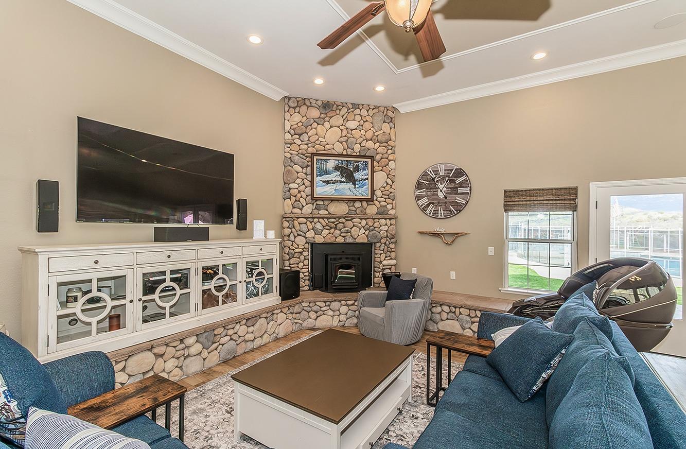21777 Tollhouse Road Clovis, CA 93619 - Photo 9 of 99 a living room with furniture a flat screen tv and a fireplace