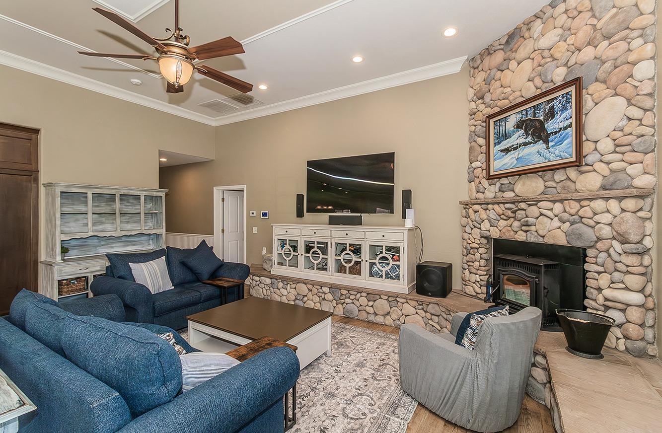 21777 Tollhouse Road Clovis, CA 93619 - Photo 10 of 99 a living room with furniture a flat screen tv and a fireplace
