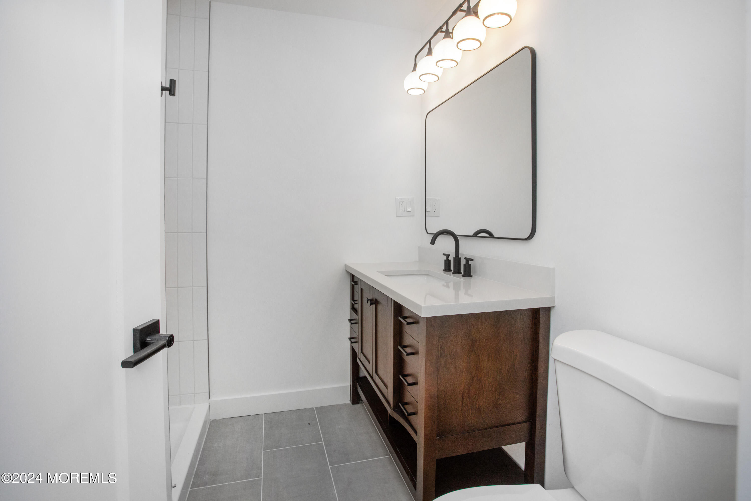 1503 Adrienne Road Wall, NJ 07719 - Photo 18 of 36 a bathroom with a sink and a mirror