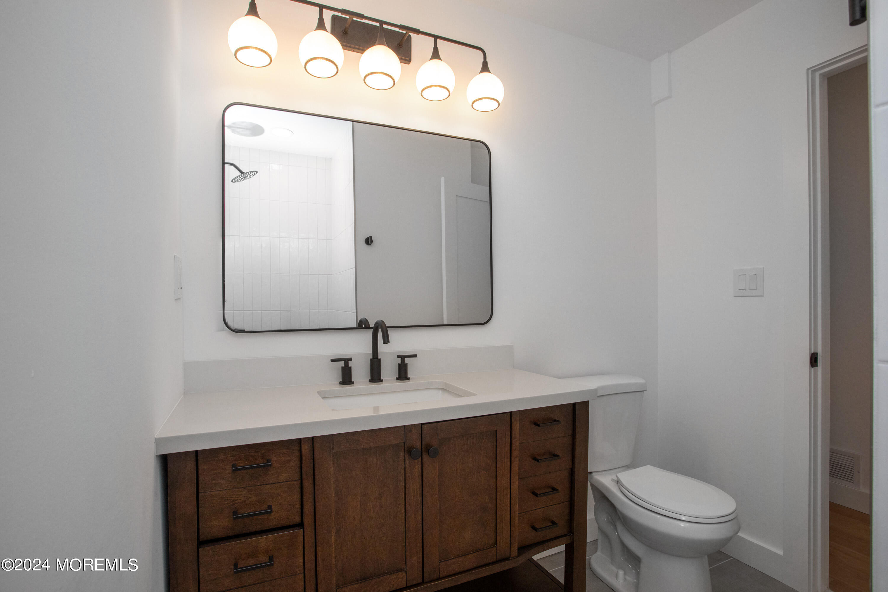1503 Adrienne Road Wall, NJ 07719 - Photo 19 of 36 a bathroom with a toilet sink and mirror