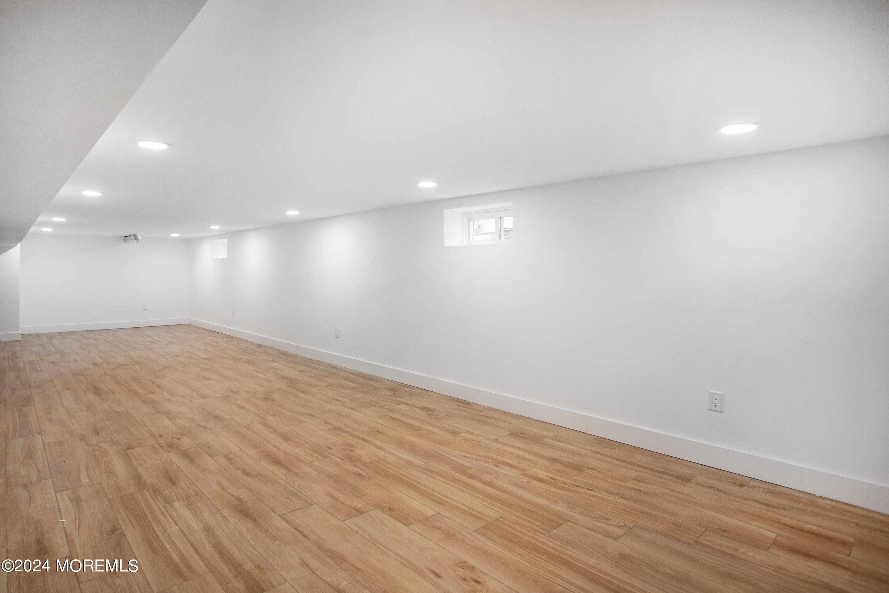 1503 Adrienne Road Wall, NJ 07719 - Photo 31 of 36 an empty room with wooden floor and entrance
