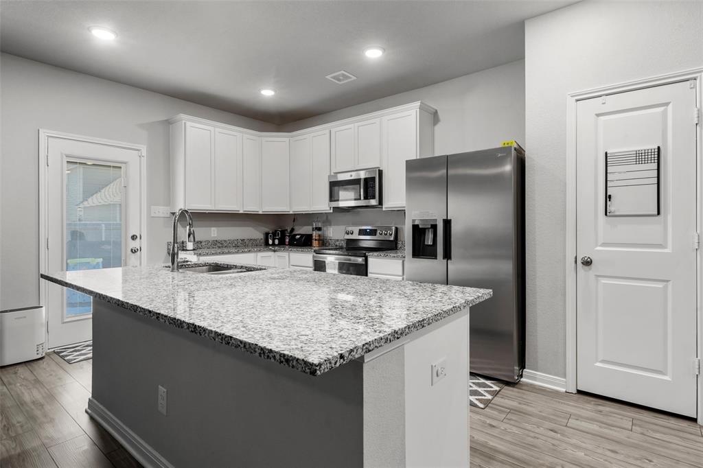 3525 Beutel Road Lorena, TX 76655 - Photo 6 of 34 a kitchen with stainless steel appliances granite countertop a refrigerator a sink a stove a microwave and island