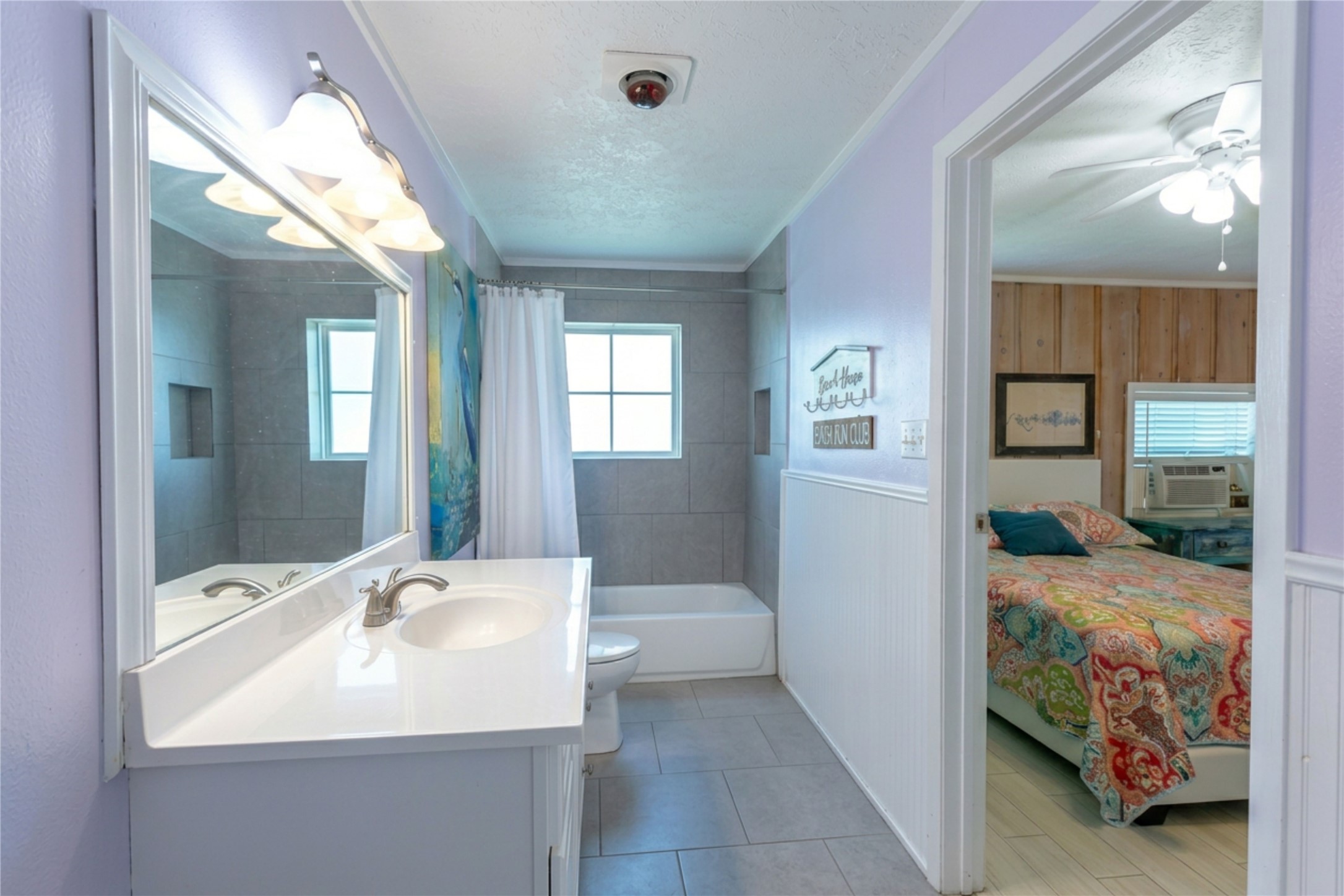 959 South East Road Crystal Beach, TX 77650 - Photo 18 of 20 a en suite bathroom with a double vanity sink and a mirror