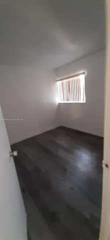a bathroom with a granite countertop sink a mirror and bathtub