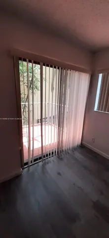 a view of balcony with wooden floor and fence