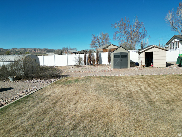 1852 East 3500th Street South Vernal, UT 84078 - Photo 40 of 46 Fenced backyard featuring a shed