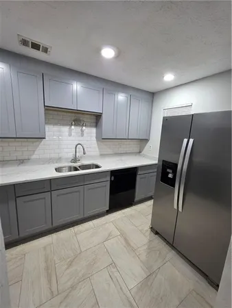 a white toilet sitting next to a bathroom sink