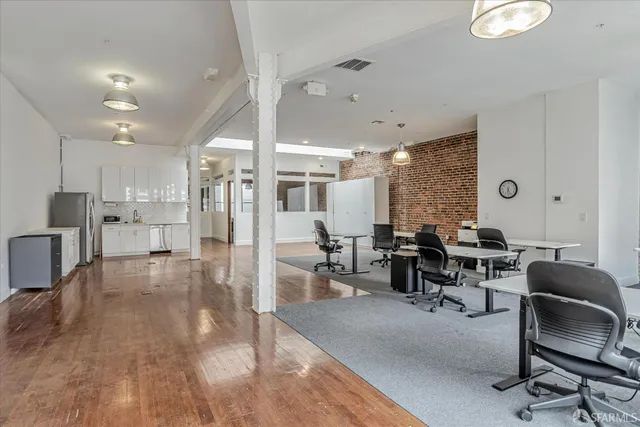 a work room with furniture and a large window