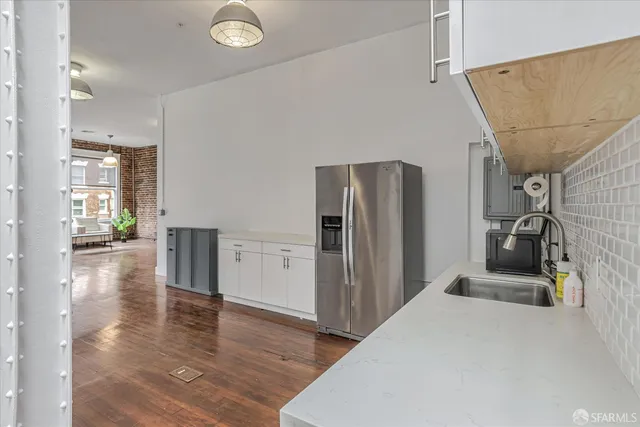 a view of a kitchen with a refrigerator and a stove