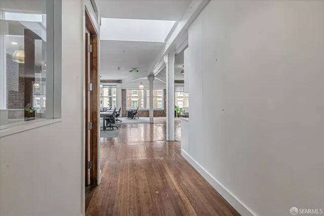 a view of a livingroom with furniture and a hardwood floor