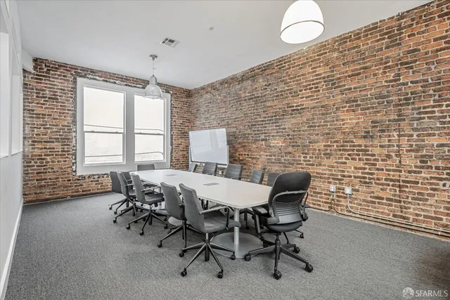 a view of a dining room with furniture and window