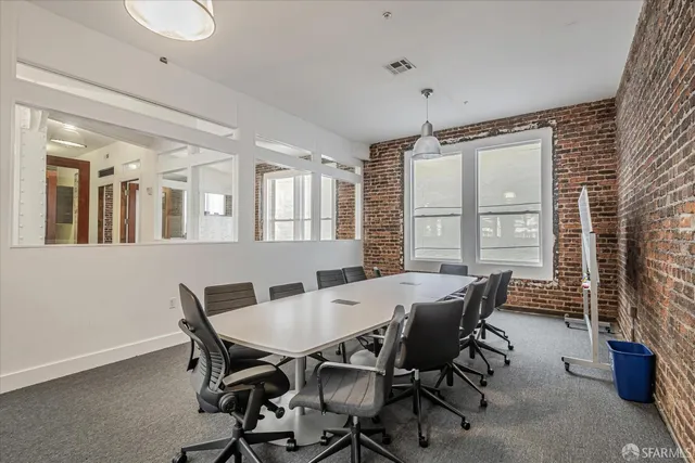 a view of a dining room with furniture and window