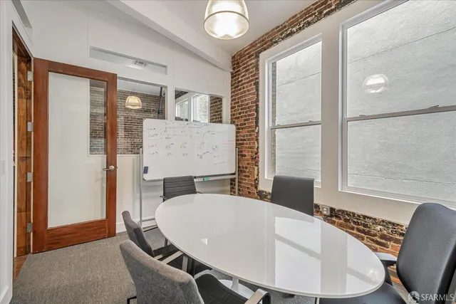 a view of a livingroom with workspace and a window