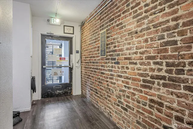 a view of wooden floor and brick walls