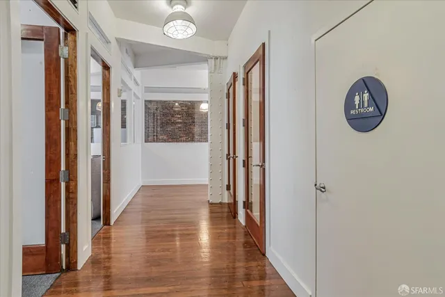a view of an entryway with wooden floor