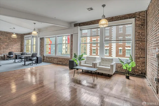a living room with furniture and floor to ceiling windows