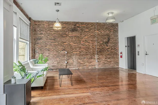a view of empty room with wooden floor and floor to ceiling window