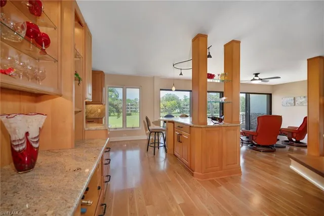 a living room with furniture a large window with wooden floor