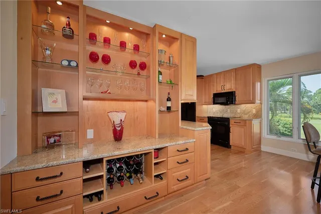 a kitchen with stainless steel appliances a stove a sink and a refrigerator