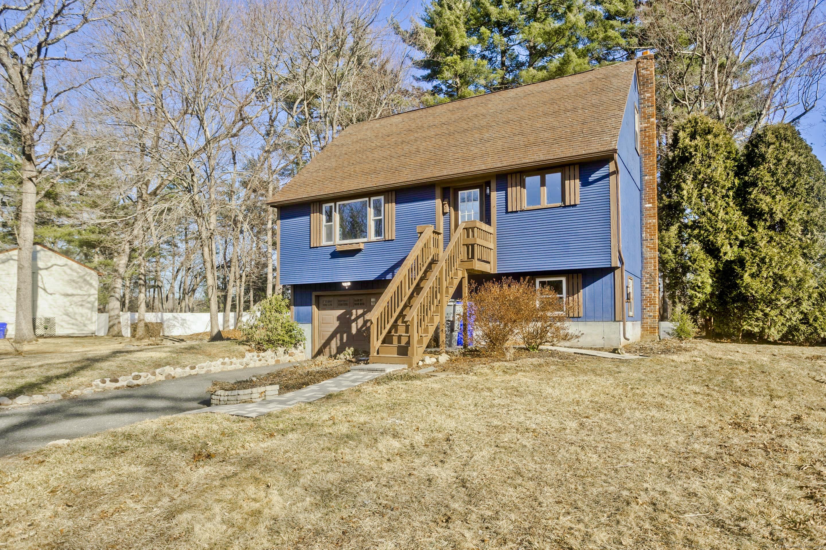 a view of a wooden house with a yard