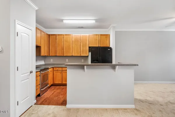 an empty room with a fireplace and a ceiling fan