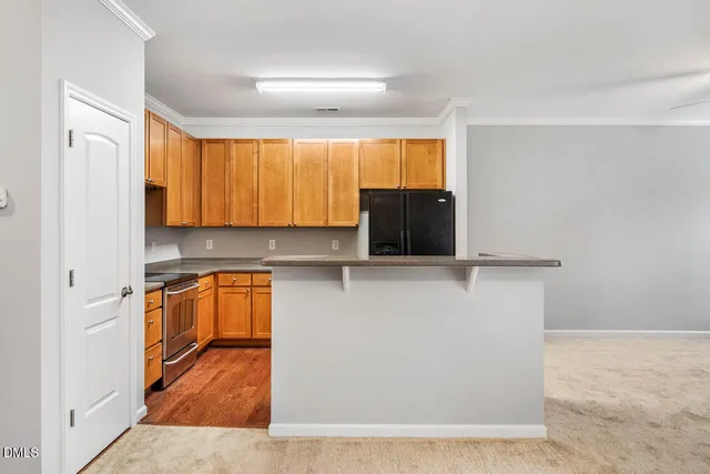 an empty room with a fireplace and a ceiling fan