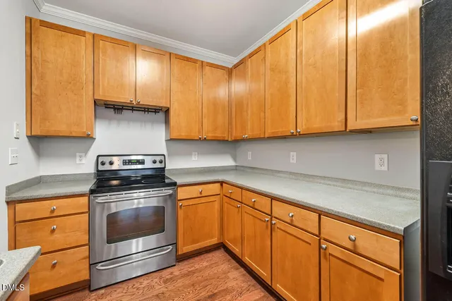 a kitchen with stainless steel appliances granite countertop a refrigerator and a stove top oven