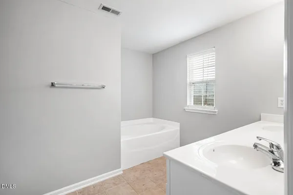 an empty room with a ceiling fan and a window
