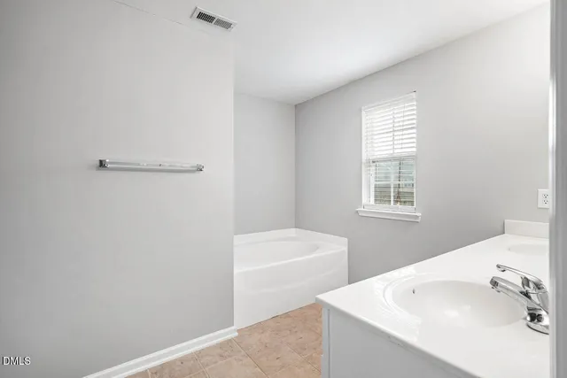 an empty room with a ceiling fan and a window