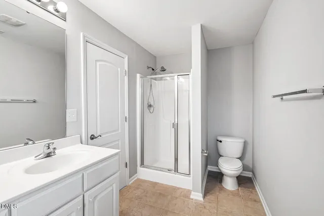 a bathroom with a double vanity sink a mirror and a bathtub