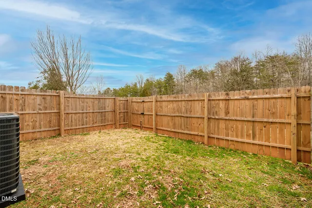 a view of a house with a wooden fence