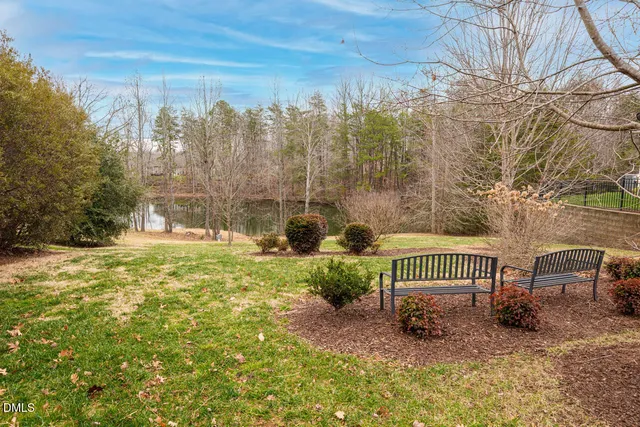a view of a backyard with wooden fence