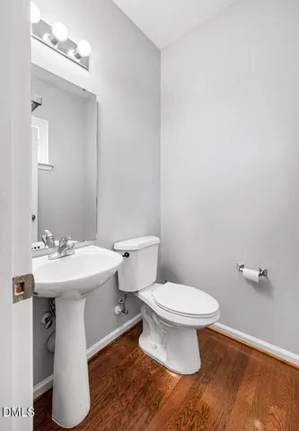 a bathroom with a sink toilet and a mirror