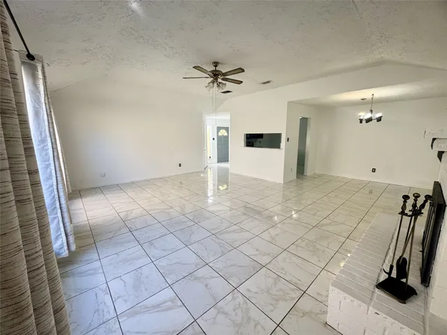 a view of empty room with ceiling fan