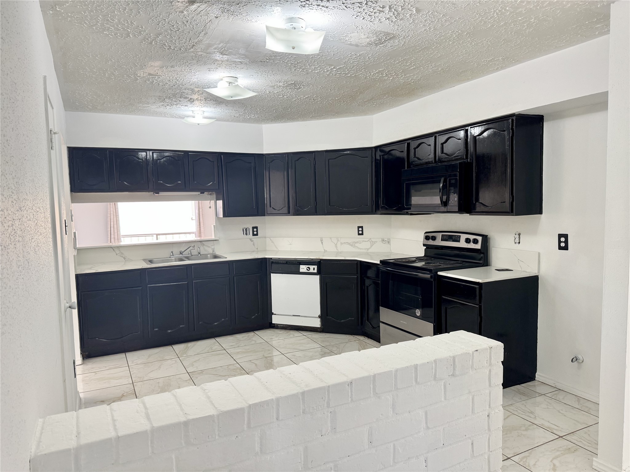 20121 Cottonglade Lane Humble, TX 77338 - Photo 3 of 10 a kitchen with stainless steel appliances kitchen island granite countertop a refrigerator and a stove top oven