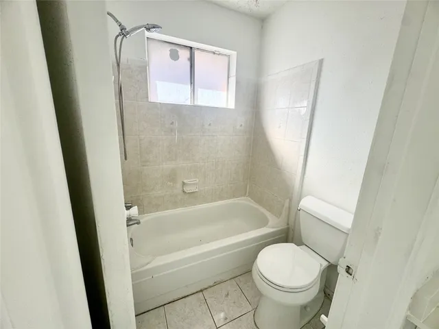 a bathroom with a toilet and a bathtub