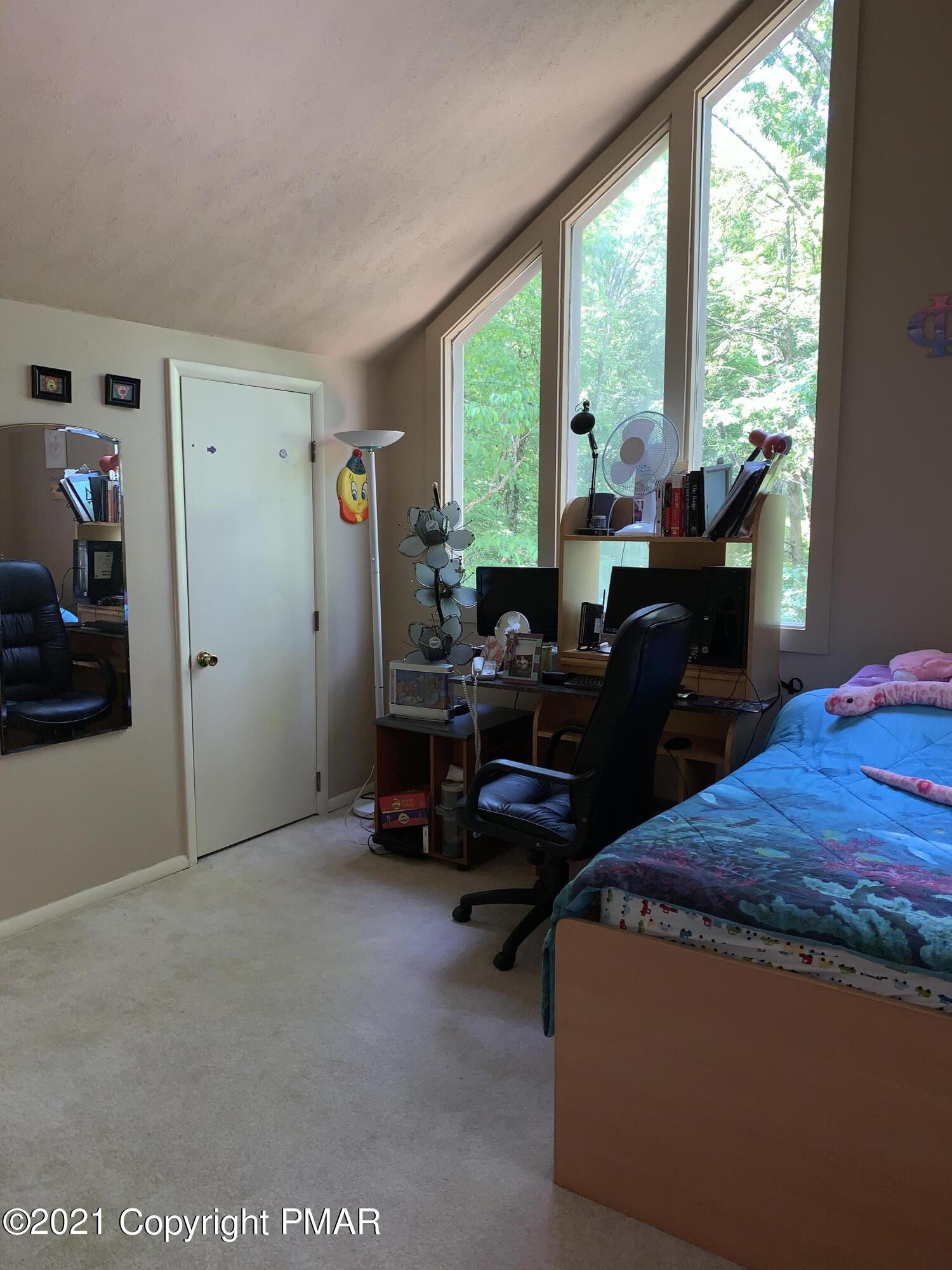 227 Canterbury Road Bushkill, PA 18324 - Photo 32 of 68 a bed room with furniture and a large window